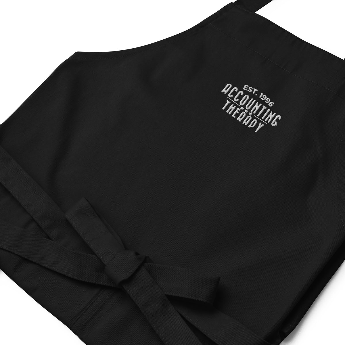 Product mockup - Close-up of organic cotton apron in black showing rope neck strap detail and textured fabric stitching